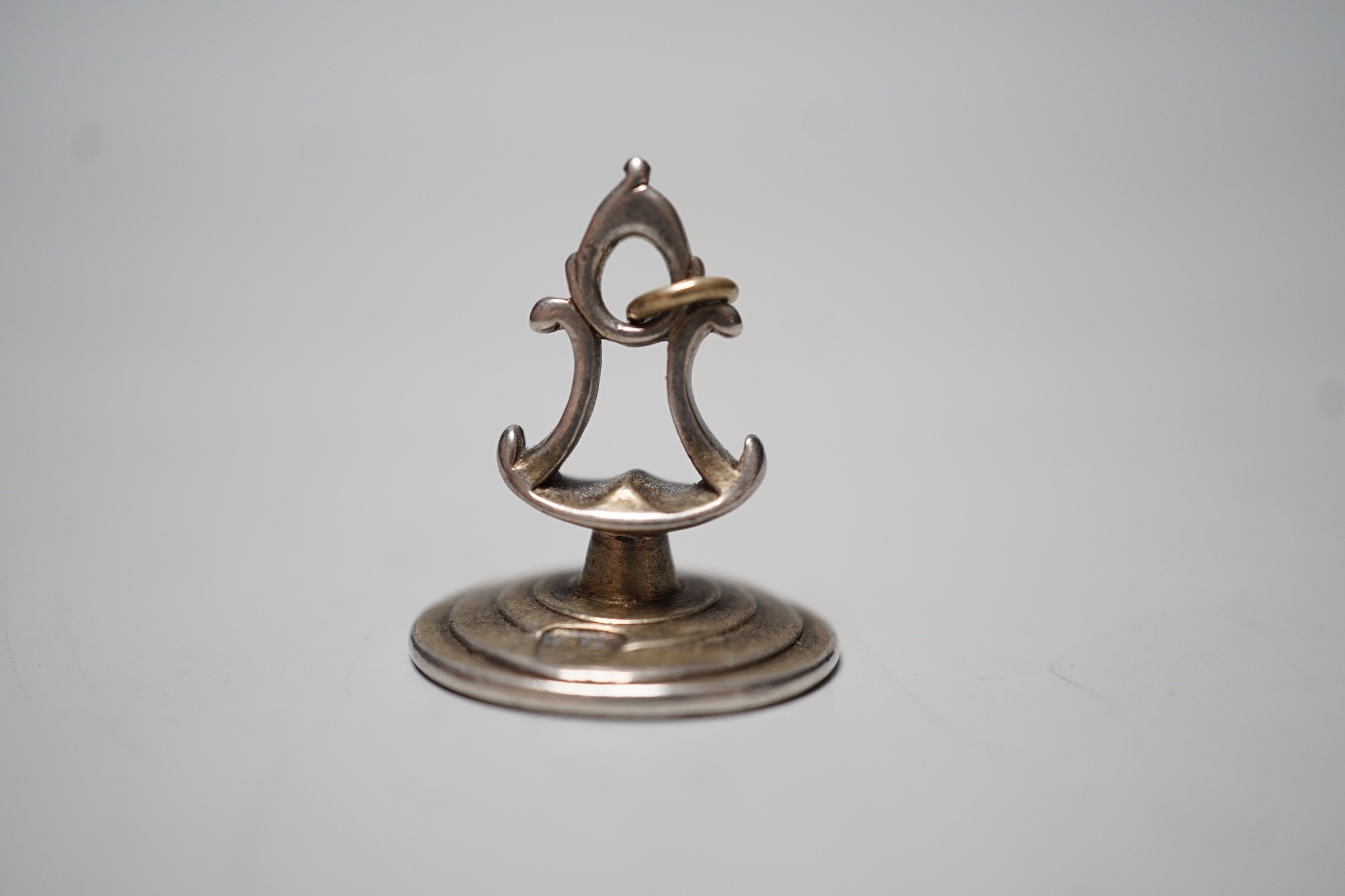 A George III silver fob seal, the matrix engraved with monogram below a crest, indistinct maker's mark ?B, 25mm.
